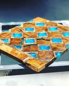 a close up of a wooden object with blue and brown squares on it's surface