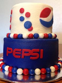 there is a pepsi cake with red, white and blue frosting on the top