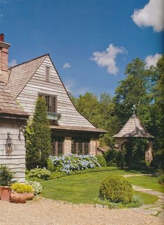 a large house sitting on top of a lush green field