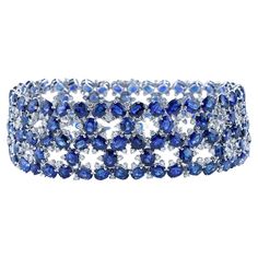 Introducing our stunning Multi-Row Sapphire and Diamond Fashion Bracelet, a masterpiece of sophistication and style. Crafted with exquisite artistry, this bracelet boasts a captivating design that effortlessly combines timeless elegance with contemporary flair. Made of 18K white gold and weighing approx. 33 grams, this bracelet measures 7 inches in length and 7/8 inch in width. Adorned with a breathtaking array of gemstones, it features 144 oval cut natural blue sapphires, totaling an impressive Brilliant Cut Sapphire Bracelets For Wedding, Sapphire Jubilee Bracelet For Wedding, Modern Bracelets, Gold Armband, American Modern, Blue Sapphire Diamond, Fabulous Jewelry, Natural Blue Sapphire, Diamond Fashion