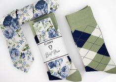 three socks and two ties laid out on top of each other, one with blue flowers