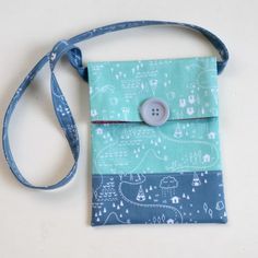 a blue and white bag with a button on it