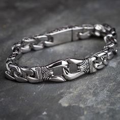 Awesome chunky curb link bracelet in solid stainless steel with Celtic designs on edges and 'heads'. Simple and secure fastening mechanism. Available in a choice of three lengths - 20cm (8"), 22cm (8.7") and 24cm (9.5") Bracelet is approximately 0.24" (6mm) thick and 0.4" (10mm) wide with the heads extending to 0.6" (15mm). Weight approximately 1.8oz-2.1oz (50-60g) depending on length Adjustable Stainless Steel Link Bracelets, Adjustable Cuban Link Bracelet With Stainless Steel Clasp, Adjustable Silver Bracelet For Outdoor, Adjustable Gunmetal Stainless Steel Bracelets, Adjustable Gunmetal Stainless Steel Bracelet, Gunmetal Stainless Steel Chain Bracelet, Adjustable Stainless Steel Gunmetal Bracelet, Gunmetal Jewelry With Stainless Steel Clasp, Adjustable Durable Silver Bracelet