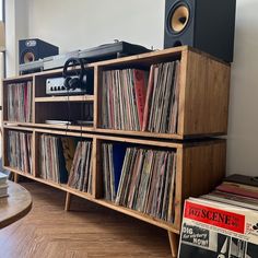 an old record player sitting on top of a wooden shelf