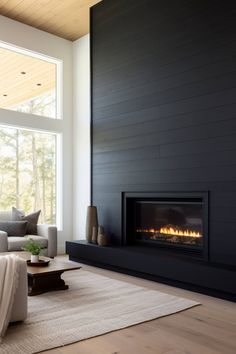 a living room with a couch, fireplace and large windows