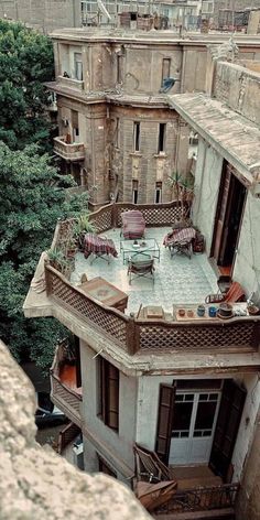 an old building with lots of windows and balconies on the top floor is seen from above