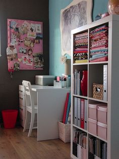 a room with a desk, bookshelf and shelves filled with various crafting supplies