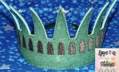 a green crown sitting on top of a blue cloth