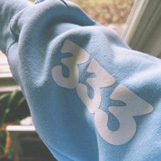 This light blue sweatshirt is a unique as it combines style and spirituality. The soft and comfortable fabric is perfect for lounging around or going out and about.  One of the most distinctive features of this sweatshirt is the angel numbers on the sleeve. Angel numbers are believed to be messages from angels that offer guidance and support, so having them on your clothing is a reminder of their presence and guidance in your life. Whether you believe in the spiritual significance of angel numbers or not, this sweatshirt is sure to attract attention and spark conversations. Angel numbers are placed on the inside of the right sleeve. Color: White 50% Cotton & 50% Polyester - this will shrink a little! SIZE UP for an oversized fit! Light Blue Sweatshirt With Ribbed Cuffs For Spring, Oversized Blue Sweats For Spring, Light Blue Relaxed Fit Sweatshirt For Streetwear, Light Blue Sweatshirt For Spring Loungewear, Light Blue Sweatshirt For Spring Streetwear, Blue Long Sleeve Sweats For Spring, Spring Blue Long Sleeve Sweats, Light Blue Cotton Hoodie For Loungewear, Light Blue Sweatshirt With Ribbed Cuffs For Streetwear