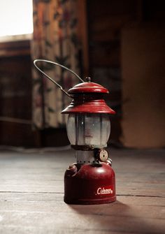 a red lantern sitting on top of a wooden floor