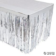 a white table topped with lots of silver foil fringes