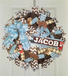 a wreath made out of fabric with the name jacob on it and moose decorations