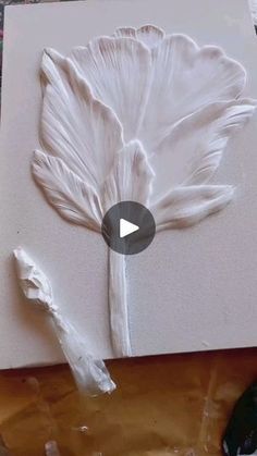 a piece of paper that has been made to look like a flower with white paint on it