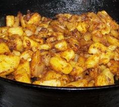 some food is cooking in a pan on the stove and ready to be cooked into something