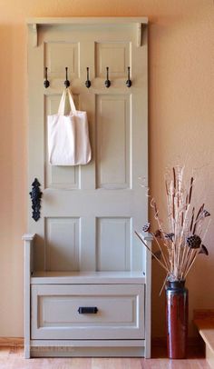 an entryway with a bench and coat rack