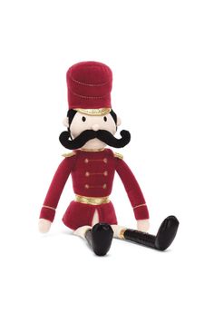 a stuffed toy with a pipe in it's mouth and wearing a red uniform