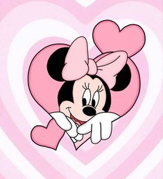 a minnie mouse cartoon peeking out from behind a heart