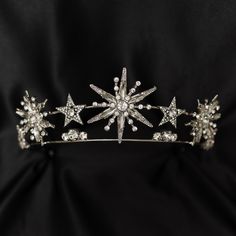 Angelica's tiara features star designs that remind me of a shooting star. Great for an ice princess or a rising (or shooting) star, Angelica sparkles and shines like the night sky or twinkling falling snow flakes.  Max Height At Center: 2.1 inches Total Length End to End: 15.5 Inches Total Length of Embellishment: 11.5 Inches Head Opening is Adjustable  WARNING: CHOKING HAZARD This item is not intended for use by children under the age of 5 years old.  There are small pieces that could fall off Halo Tiara, Star Tiara, Celestial Wedding Theme, Starry Wedding, Starry Night Wedding, Celestial Crystal, Star Crystal, Moon Wedding, Bride Tiara