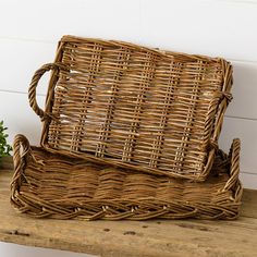 two wicker baskets sitting on top of a wooden table