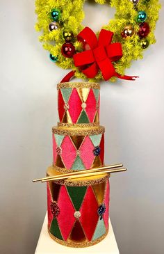 three tiered christmas cake with wreath on top