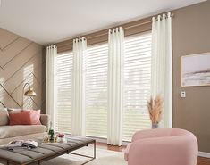 a living room filled with furniture and windows covered in blinds