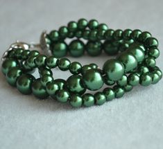 I make the bracelet to use 6mm and 10mm dark green glass pearls.The bracelet length is 8 inches ,It is fit to 6.5-7 inches wrist,IT has a 2 inches long adjustable chain.IT is good bracelet for your great wedding. I can make different type bracelet to your requirements,Please feel free to contact me if you have any question. Thank you so much. . The other dark green pearl jewelry https://www.etsy.com/shop/glasspearlstore/search?search_query=dark+green&order=date_desc&view_type=list&re Green Multi-strand Bracelets For Jewelry Making, Green Round Bead Bracelets For Wedding, Green Round Beads Bracelets For Wedding, Green Round Beaded Wedding Bracelets, Dark Green Bracelet, Green Pearl Jewelry, Good Bracelet, Green Beaded Bracelets, Green Bracelet