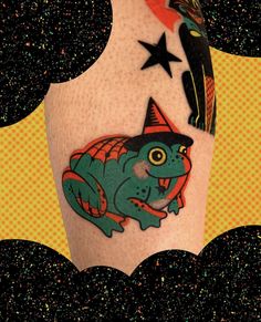 a colorful tattoo on the leg of a person wearing a hat and holding a star