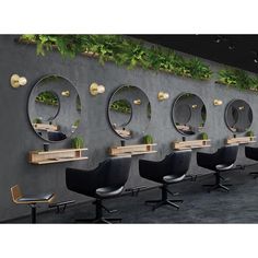 a row of chairs sitting next to each other in front of a wall with mirrors on it