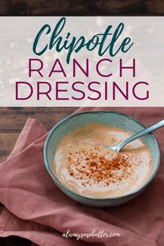 a bowl filled with ranch dressing on top of a wooden table next to a red napkin