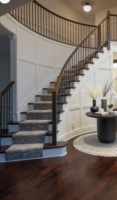 a living room filled with furniture and a spiral staircase