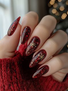 Get festive with these stunning dark red nails, accented with shimmering gold glitter and delicate snowflake details! This luxurious manicure combines the rich, deep tones of the holiday season with a sparkling touch, perfect for any Christmas celebration. Whether you're dressing up for a party or simply want to add some holiday cheer to your look, these nails are sure to stand out.  #ChristmasNails #HolidayManicure #RedNails #SparkleNails #WinterNailArt #FestiveNails Red Nails Gold Snowflake, Nails Christmas Red And Gold, Dark Christmas Red Nails, Red And Gold Snowflake Nails, Dark Red Gold Nails, Dark Red Nails Glitter, Red Nails Gold Accent, Dark Red Holiday Nails, Dark Red Nails Christmas