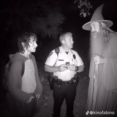 three men dressed up as wizard and ghost standing next to each other in the dark