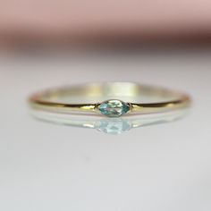 a gold ring with a blue diamond on it