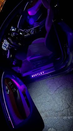 the interior of a car with purple lights