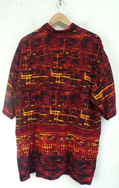 "-Description- >men's red, orange, & yellow printed shirt >collared >button front >short sleeve >size XL >bold print! >condition: excellent >color(s): red, orange, yellow >fabric(s): rayon >brand: puritan >care: machine wash -Measurements- >size: XL ✩ all measurements are taken with the item laying flat & some sizes are estimates so please check measurements ✩ chest: 52\" / 132cm length: 32\" / 81cm shoulder to sleeve end: 11.5\" / 29cm shoulders: 22\" Red Graphic Print Shirt With Camp Collar, Red Camp Collar Shirt With Graphic Print, Red Camp Shirt With Graphic Print, Red Camp Collar Top With Graphic Print, Red Relaxed Fit Graphic Print Camp Shirt, Casual Red Shirt With Vibrant Print, Red Graphic Print Collared Top, Red Collared Top With Graphic Print, Red Graphic Print Short Sleeve Hawaiian Shirt