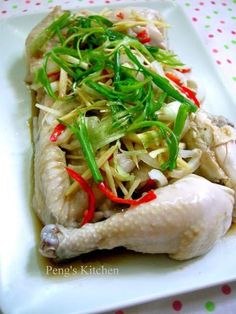 a white plate topped with chicken and veggies