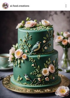 a green cake decorated with flowers and birds