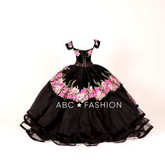 Dazzle the room in this off the shoulder floral ballgown by Ragazza Fashion MV15-115. Made out of velvet, this beautiful charro dress features a lovely off the shoulder bodice embellished with beautiful floral embroidery, long A-line layered skirt, eye-catching train, and a lace-up corset back. Available Matching little girl's dress is Ragazza Fashion Style N08-708. En Espanol: La pieza más emblemática de esta colección, encarnando el espíritu mexicano e innovando a través de su increíble Tercio Charro Dress, Floral Ballgown, Charro Quince, Charro Quinceanera Dresses, Mexican Themed Weddings, Black Quinceanera Dresses, Quince Dresses Mexican, Quinceñera Dresses, Mary's Bridal