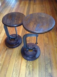 two wooden stools sitting on top of a hard wood floor next to each other