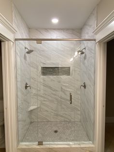 a walk in shower sitting inside of a bathroom