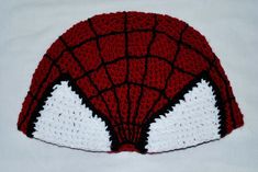 A crochet Spider-Man hat with hand sewn detailing. Will fit most adults. This hat is made to order so that I can customize the size from adults to children. See image for Measurement Guide: Measurement A: The brim of the hat, where it sits on the crown of your head, is about 23 inches, and can stretch to about 25 inches. Measurement B: From front of hat to the back (where is sits on your brow to the back of your head), is about 16 inches. Customization includes the size of the hat. Send me the measurements as shown in the image. Can be customized for adults, teenagers, and children. These items are handmade to order so I can customize each one, so please excuse the delay, each one will be shipped out 3-5 days after ordering. Themed Red Hat One Size Fits Most, Fitted Knitted Cap, Fitted Yarn Beanie Hat, Fitted Yarn Cap, Fitted White Crochet Hat, Handmade Fitted White Hat, Fun Crochet Cap, One Size Fits Most, Fun Crochet Cap One Size Fits Most, Fun One-size Crochet Cap