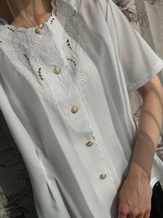 - Vintage white blouse top with embroidery - Good vintage condition  - TAG SIZE: 38 - Fabric information: 100% polyester Estimated to fit XS-S-M-L-XL based on your desired fit. Measurements (laying flat): - Shoulders (back): 40 cm - Length: 60 cm - Sleeve: 25 cm - Armpit to armpit: 56 cm Vintage clothes may come with minor flaws due to pre-loved wear. But most importantly it is a one-of-a-kind piece with its own character. By shopping secondhand you're giving a second life and not contributing t Elegant White Embroidered Short Sleeve Top, Elegant Crew Neck Top With Floral Embroidery, Elegant Floral Embroidered Crew Neck Top, Elegant White Tops With Floral Embroidery, Elegant Crew Neck Top With Buttons, Elegant White Crew Neck Blouse, Vintage White Blouse, White Blouse Top, Womens Blouses