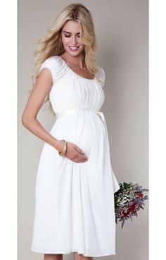 Adored for its stunning simplicity, our popular Claudia maternity wedding dress now comes in a demure knee-length version that's perfect for an intimate country house wedding. Elegant Flowy Maternity Dress With Empire Waist, Flowy Empire Waist Maternity Dress For Wedding, Flowy White Maternity Dress For Wedding, Elegant White Maternity Wedding Dress, Elegant White Maternity Dress For Bridal Shower, Elegant Cream Maternity Dress, Elegant White Maternity Bridesmaid Dress, Maternity Gown Styles, Tiffany Rose