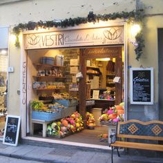 a store front with lots of fresh produce on display