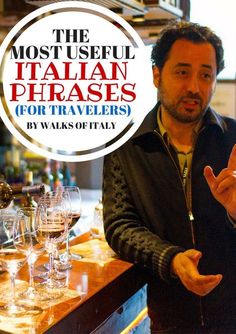 a man standing in front of a bar with wine glasses on it and the words, most useful italian phrases for travelers by walks of italy