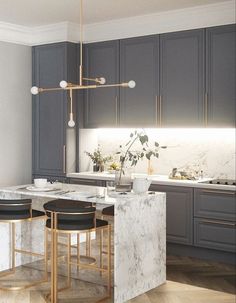 a kitchen with marble counter tops and stools in front of an island that is surrounded by gray cabinets