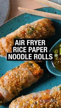 an image of some food on a plate with chopsticks and broccoli