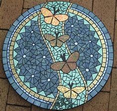 a stained glass plate with butterflies on it