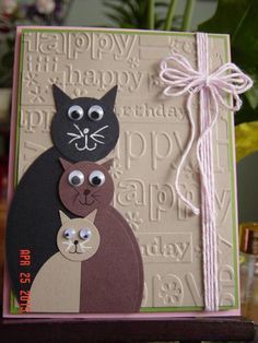 a close up of a card with a cat on it's face and another cat in the background