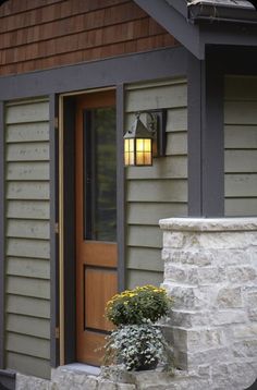 the front door of a house with a planter on it